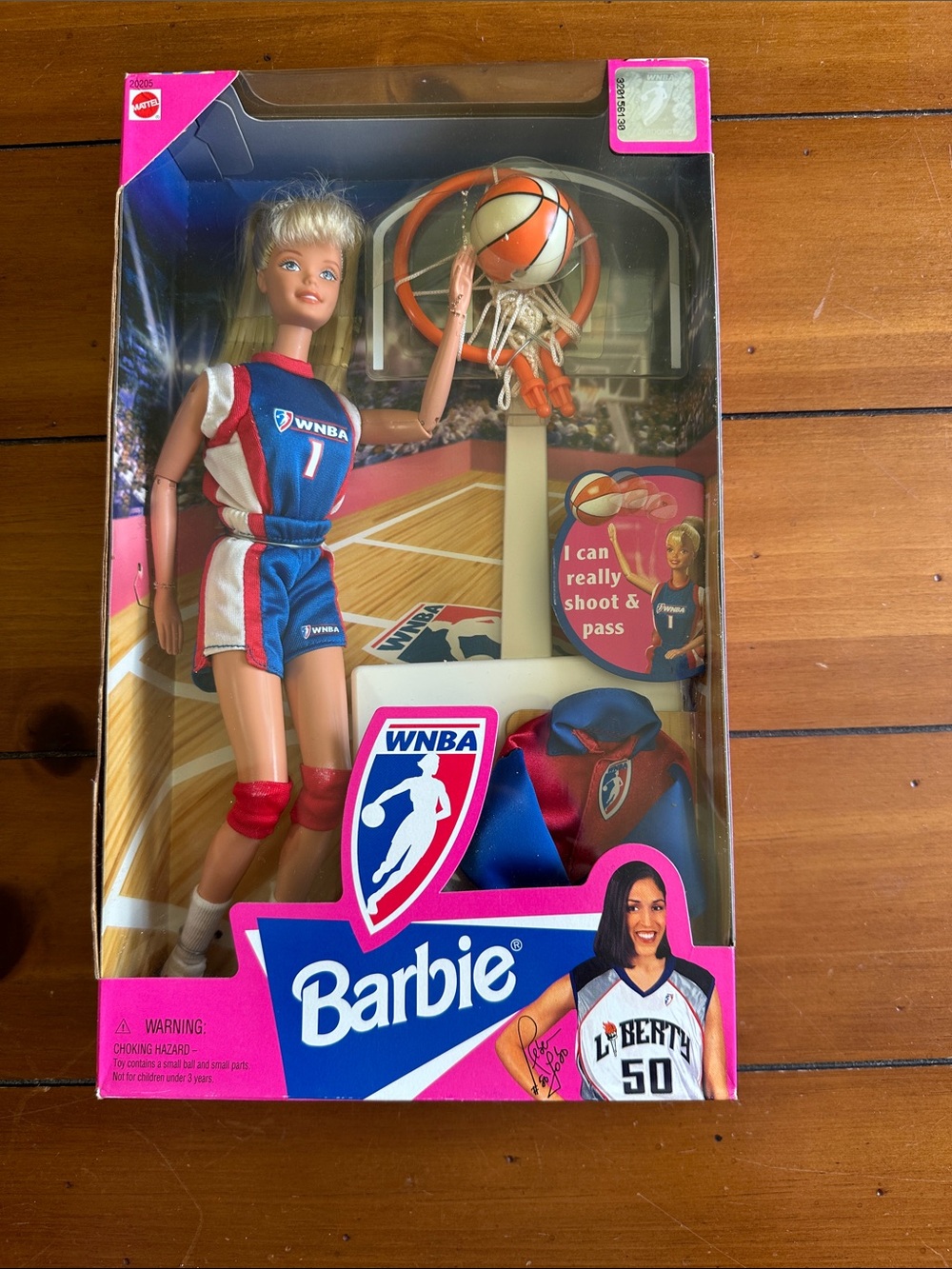 Vintage WNBA Barbie with basketball hoop and throwing action.